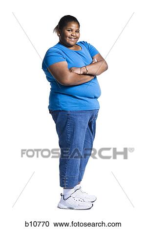 Stock Image - Heavyset young woman with arms folded. Fotosearch