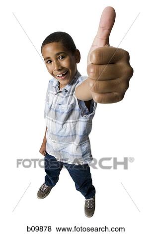 High angle view of a boy showing a thumbs up sign View Large Photo Image Stock Photo - High angle view of a boy showing a thumbs up sign. Fotosearch