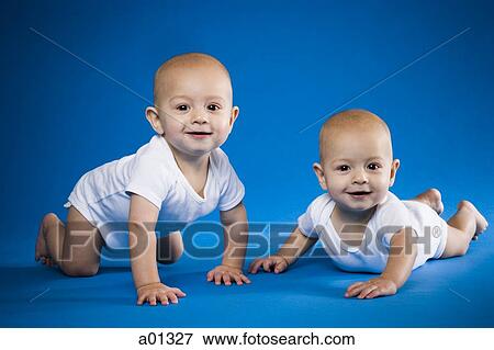 Identical twin babies crawling View Large Photo Image Stock Photo - Identical twin babies crawling. Fotosearch