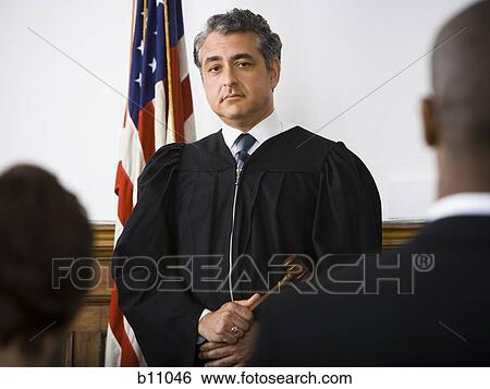 Judge standing in front of defendants and lawyers View Large Photo Image Stock Photograph - Judge standing in front of defendants and lawyers. Fotosearch