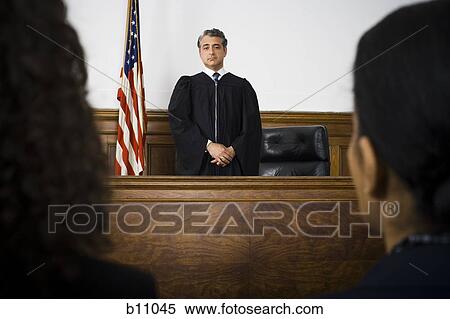 Judge standing in front of defendants and lawyers View Large Photo Image Stock Photography - Judge standing in front of defendants and lawyers. Fotosearch