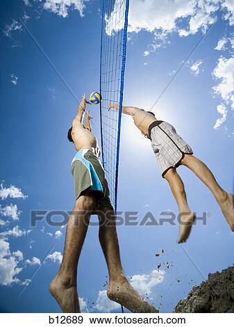 Stock Photo - Jumping volleyball players. Fotosearch