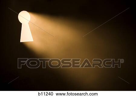 Stock Image - Keyhole with bright light beaming through. Fotosearch