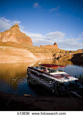 Stock Photograph - Large boat on water with rock formations. Fotosearch