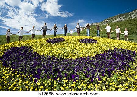 Large family group on hill with happy face floral display View Large Photo Image Stock Photograph - Large family group on hill with happy face floral display. Fotosearch