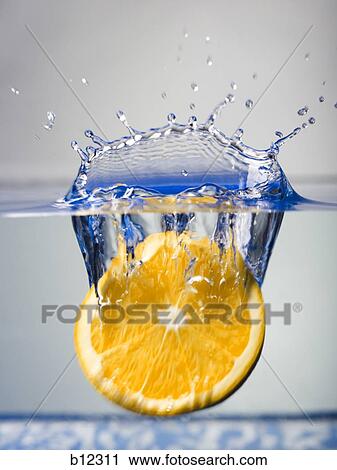 Lemon slice dropping into water View Large Photo Image Stock Image - Lemon slice dropping into water. Fotosearch