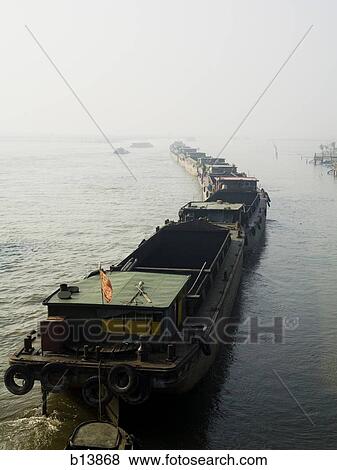 Line up of boats in water View Large Photo Image Stock Photo - Line up of boats in water. Fotosearch