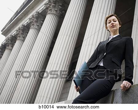 Low angle view of a female lawyer standing in front of a courthouse View Large Photo Image Picture - Low angle view of a female lawyer standing in front of a courthouse. Fotosearch