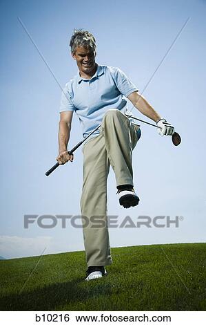 Low angle view of a man breaking a golf club View Large Photo Image Stock Photograph - Low angle view of a man breaking a golf club. Fotosearch