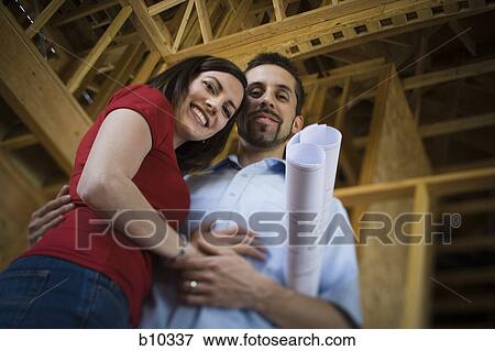 Low angle view of a young couple smiling View Large Photo Image Stock Photo - Low angle view of a young couple smiling. Fotosearch