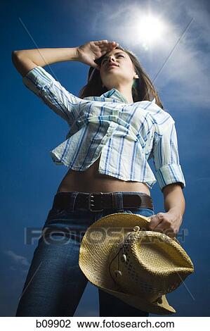Low angle view of a young woman View Large Photo Image Stock Image - Low angle view of a young woman. Fotosearch