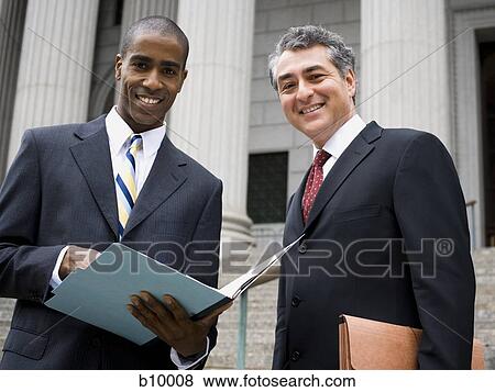 Low angle view of two lawyers smiling View Large Photo Image Stock Photo - Low angle view of two lawyers smiling. Fotosearch