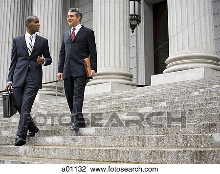 Low angle view of two male lawyers talking on the steps of a courthouse View Large Photo Image Stock Image - Low angle view of two male lawyers talking on the steps of a courthouse. Fotosearch