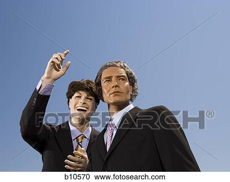 Stock Image - Low angle view of two mannequins portraying businessmen. Fotosearch