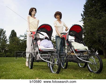 Low angle view of two mannequins portraying mothers pushing prams View Large Photo Image Stock Image - Low angle view of two mannequins portraying mothers pushing prams. Fotosearch