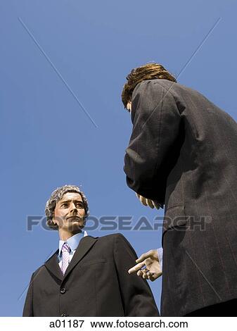 Low angle view of two mannequins portraying businessmen View Large Photo Image Stock Photo - Low angle view of two mannequins portraying businessmen. Fotosearch