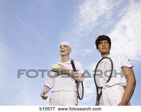 Stock Photo - Low angle view of two mannequins portraying tennis players. Fotosearch
