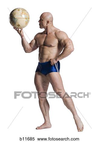 Male bodybuilder holding a desk globe View Large Photo Image Stock Photography - Male bodybuilder holding a desk globe. Fotosearch