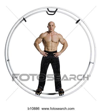 Male bodybuilder posing in German wheel View Large Photo Image Stock Photograph - Male bodybuilder posing in German wheel. Fotosearch