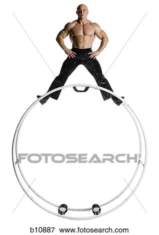 Male bodybuilder posing on top of German wheel View Large Photo Image Stock Photo - Male bodybuilder posing on top of German wheel. Fotosearch