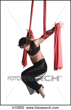 Male circus gymnast tangled in red drapes View Large Photo Image Stock Image - Male circus gymnast tangled in red drapes. Fotosearch