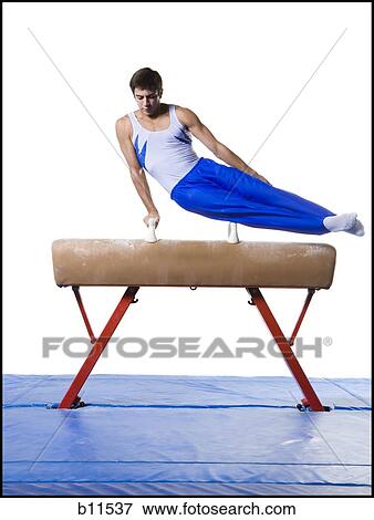 Male gymnast performing routines on vaulting horse View Large Photo Image Stock Photo - Male gymnast performing routines on vaulting horse. Fotosearch