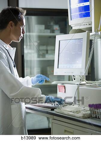 Male lab technician looking at monitors View Large Photo Image Stock Photo - Male lab technician looking at monitors. Fotosearch