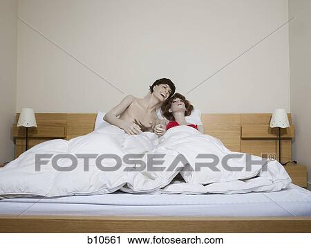 Male mannequin and a female mannequin reclining on the bed and laughing View Large Photo Image Stock Image - Male mannequin and a female mannequin reclining on the bed and laughing. Fotosearch