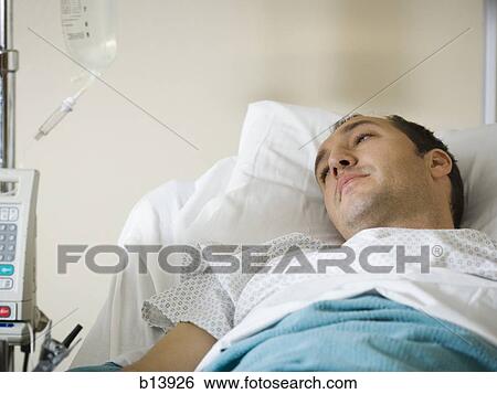 Stock Photograph - Male patient in hospital bed. Fotosearch