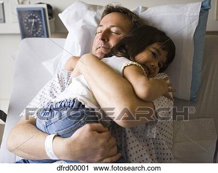 Male patient in hospital hugging young girl View Large Photo Image Stock Image - Male patient in hospital hugging young girl. Fotosearch