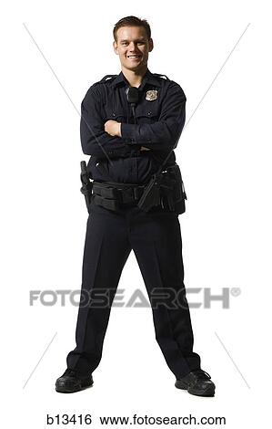 Stock Photograph - Male police officer standing with arms crossed smiling. Fotosearch