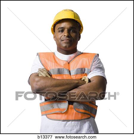 Male road worker with crossed arms and hardhat View Large Photo Image Stock Photo - Male road worker with crossed arms and hardhat. Fotosearch
