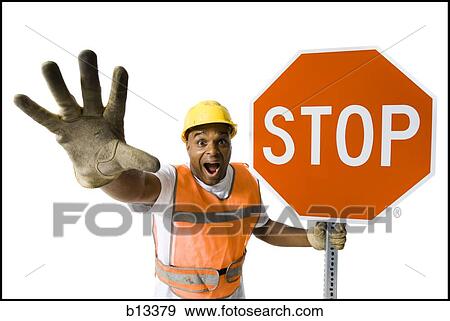 Stock Photo - Male road worker with stop sign yelling. Fotosearch