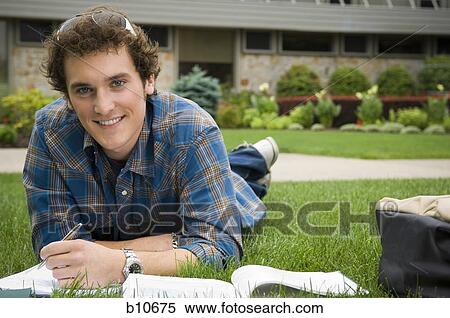 Stock Photography - Male student studying outdoors. Fotosearch