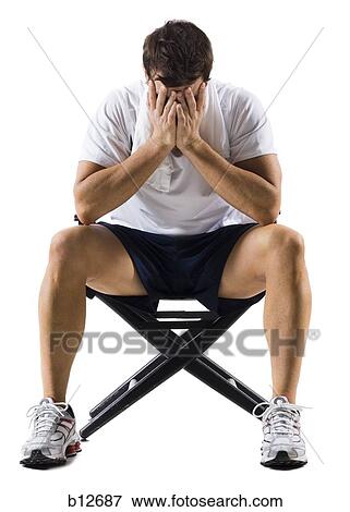 Stock Photo - Male tennis player taking a break. Fotosearch