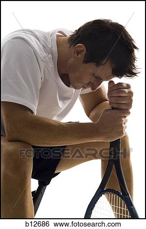 Male tennis player taking a break View Large Photo Image Stock Photograph - Male tennis player taking a break. Fotosearch