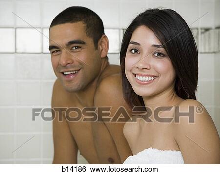 Stock Photograph - Man and woman in steam bath with towels smiling. Fotosearch