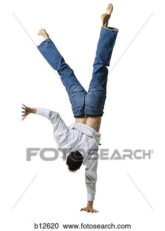 Man doing a one armed handstand View Large Photo Image Stock Image - Man doing a one armed handstand. Fotosearch