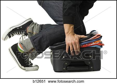 Man forcing clothes into overstuffed suitcase View Large Photo Image Stock Image - Man forcing clothes into overstuffed suitcase. Fotosearch