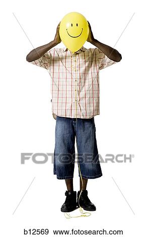 Man holding a happy face balloon View Large Photo Image Stock Photo - Man holding a happy face balloon. Fotosearch