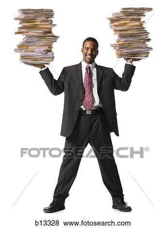 Man holding stacks of paperwork smiling View Large Photo Image Stock Photo - Man holding stacks of paperwork smiling. Fotosearch