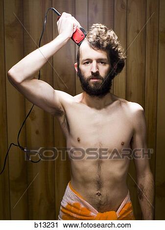 Stock Image - Man in bath towel shaving hair. Fotosearch