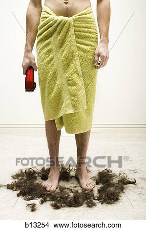 Picture - Man in bath towel with razor standing in hair. Fotosearch