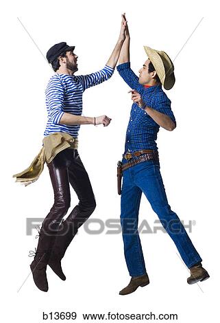 Man in cowboy costume and man in leather pants with waist sash high five View Large Photo Image Stock Photo - Man in cowboy costume and man in leather pants with waist sash high five. Fotosearch