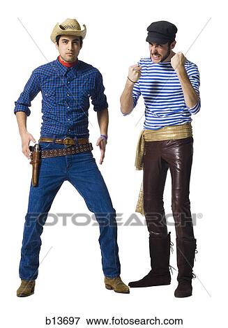 Stock Photo - Man in cowboy costume and man with leather pants and waist sash with clenched fists. Fotosearch