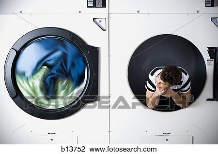 Man in dryer watching laundry View Large Photo Image Stock Image - Man in dryer watching laundry. Fotosearch