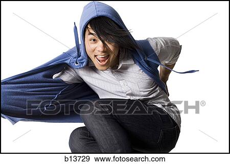 Stock Photo - Man in hoodie dancing and smiling. Fotosearch