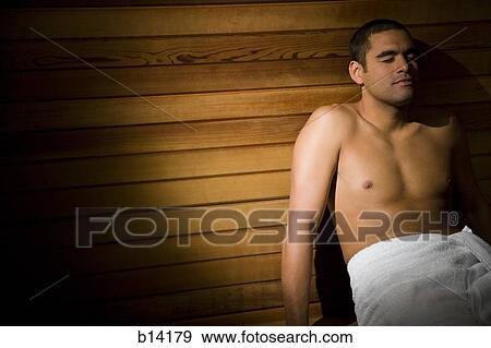 Man in sauna with towel relaxing View Large Photo Image Stock Photo - Man in sauna with towel relaxing. Fotosearch