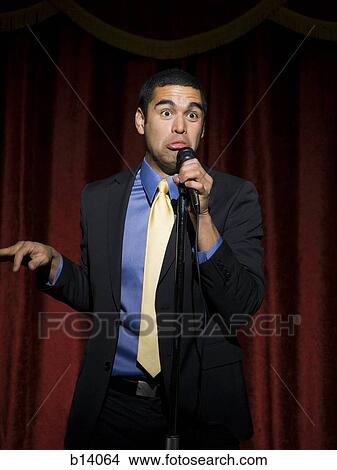 Man in suit with microphone making funny faces View Large Photo Image Picture - Man in suit with microphone making funny faces. Fotosearch