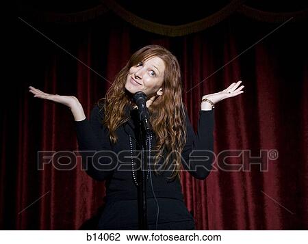 Man in suit with microphone making funny faces View Large Photo Image Stock Image - Man in suit with microphone making funny faces. Fotosearch